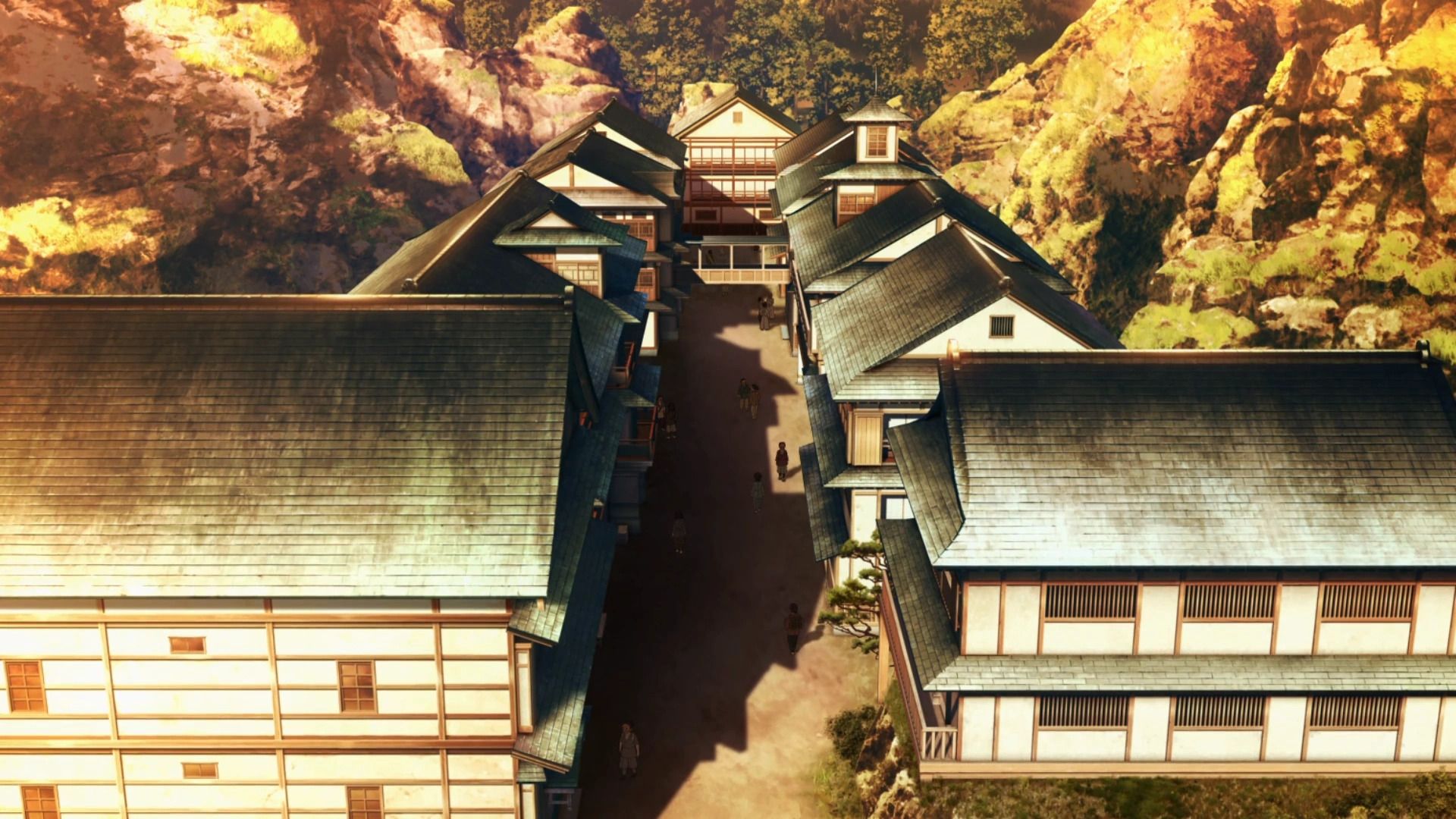 A group of buildings with a road and trees
Description automatically generated