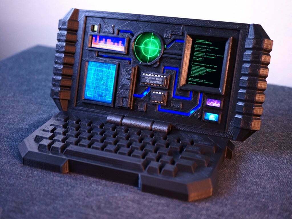 A black computer with a keyboard and a green screen
Description automatically generated