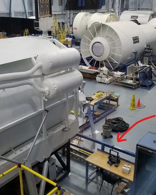 A large white machines in a factory
Description automatically generated