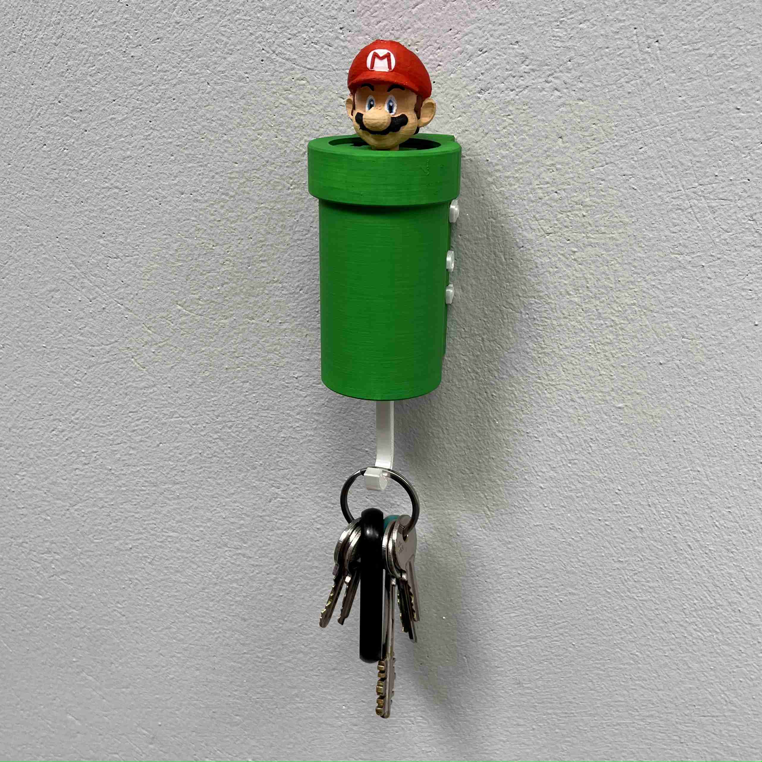 A key holder with a cartoon character
Description automatically generated